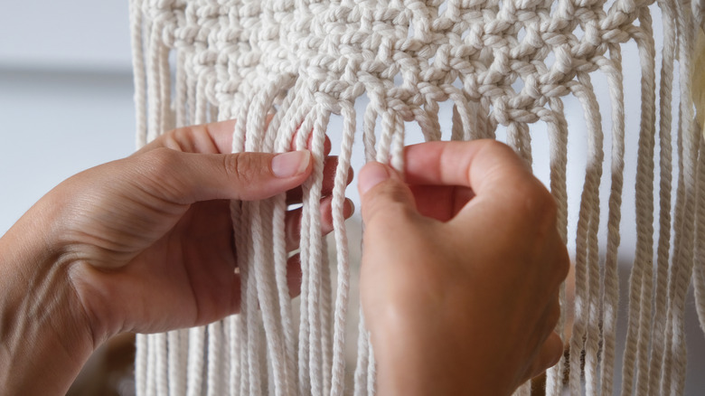 A person doing macrame