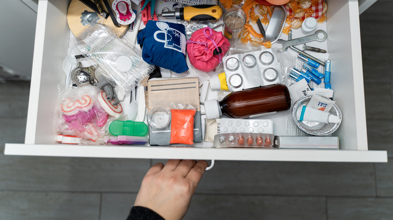 A drawer full of cluttered items.