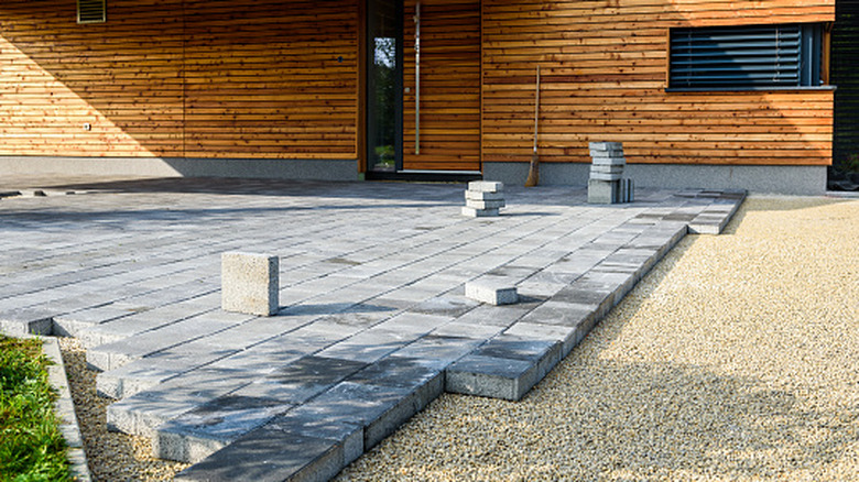 A patio being laid with concrete pavers