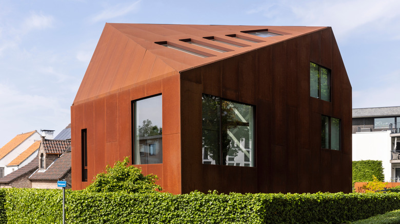 A modern building clad entirely in corten steel