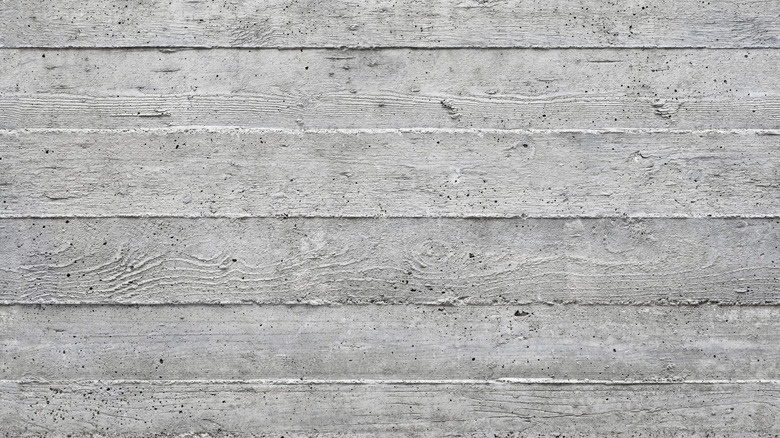 A close-up of board-formed concrete, with natural wood grains imprinted into the surface