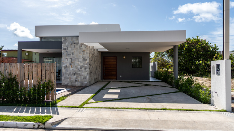 A contemporary luxury home facade with various materials