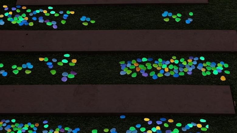 Glow-in-the-dark pebbles on a driveway at night