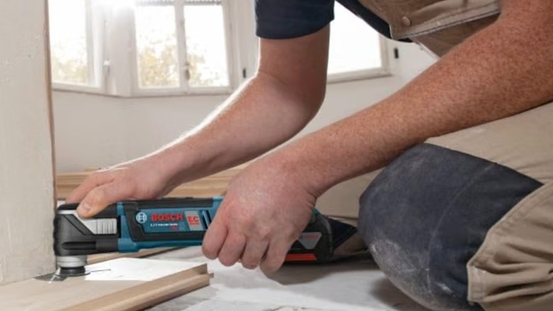 Man using the Bosch oscillating multi-tool for a home project.