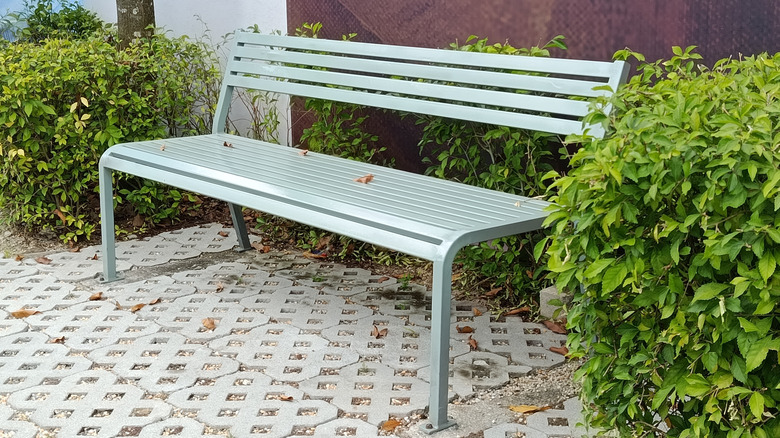 A bench sits on a patio made of permeable pavers