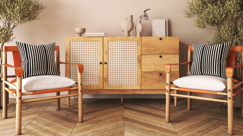 White cabinet with spindle chairs at each side.