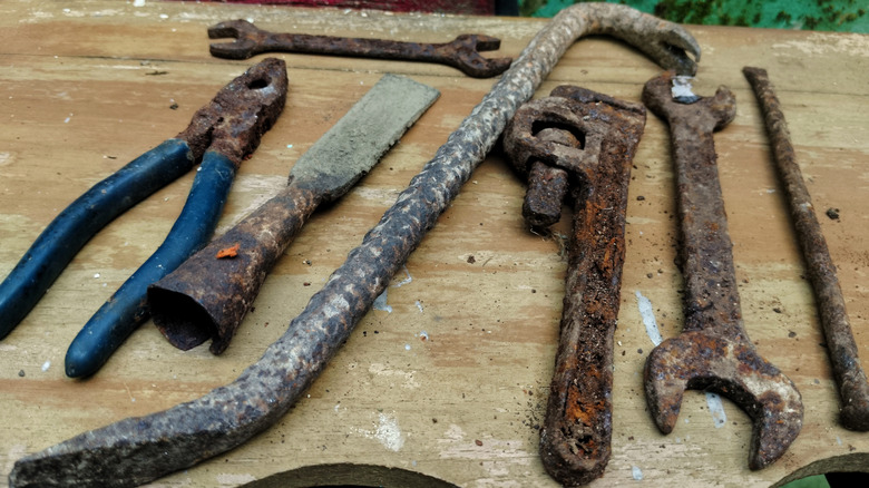 Rusty tools on wooden table