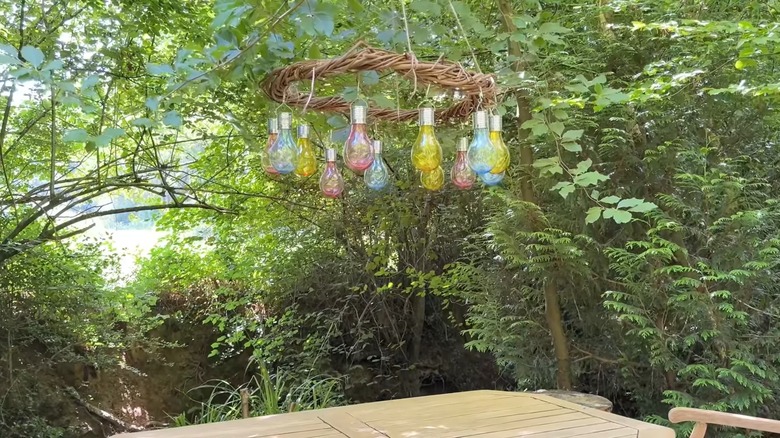 An outdoor light made from a wreath and solar light bulbs