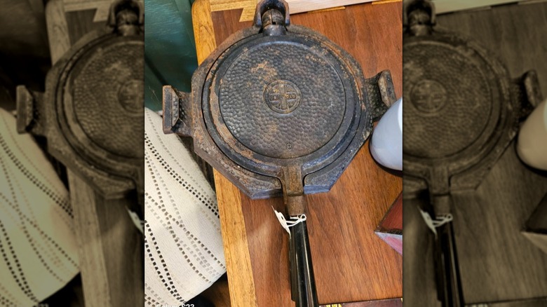 Rusted Griswold waffle iron with a hammered pattern