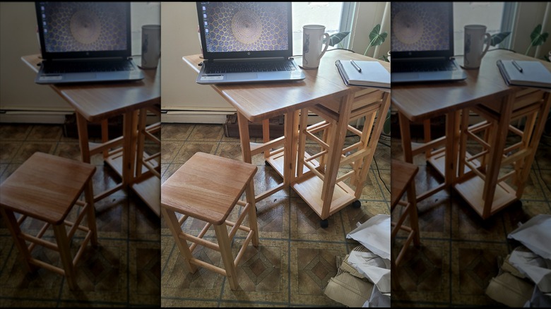 The Winsome Suzanne kitchen table in a kitchen, with laptop and coffee mug on it