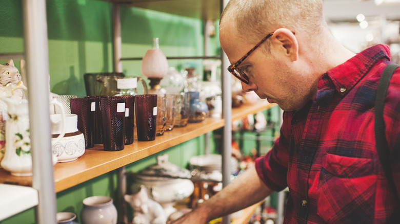 A man searching through secondhand shop items