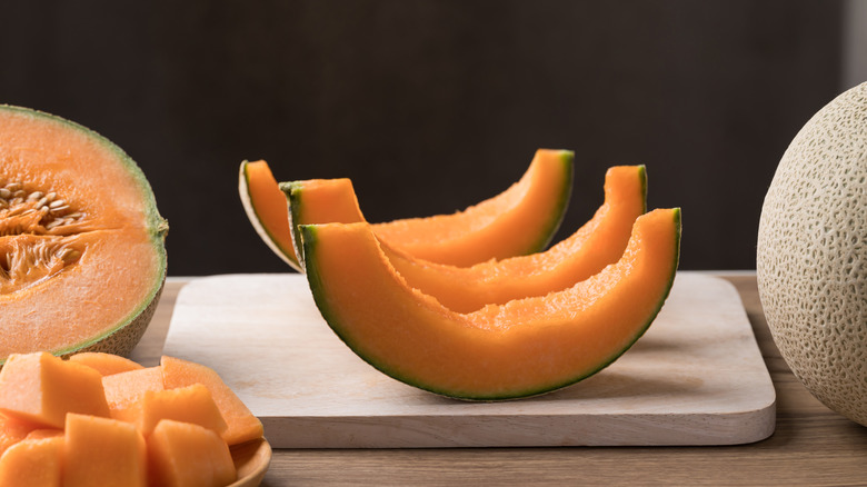 Cantaloupe rinds on a cutting board