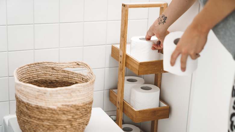 Toilet paper on a narrow shelf in a bathroom