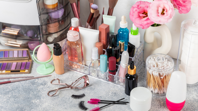 makeup in a clear plastic organizer on a vanity