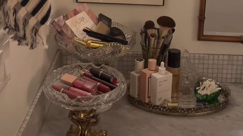 Make-up and bathroom lotions organized in thrifted containers