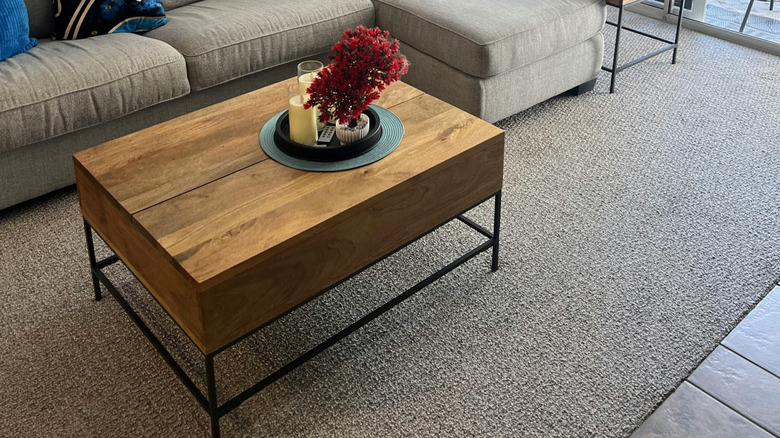 A coffee table with a built-in compartment