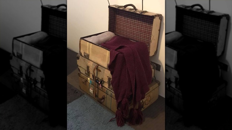 Blankets tucked into a vintage suitcase