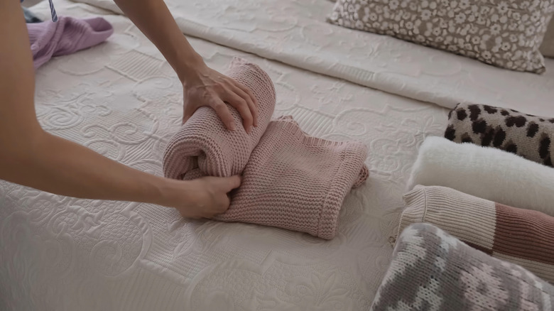 Hands rolling up a blanket
