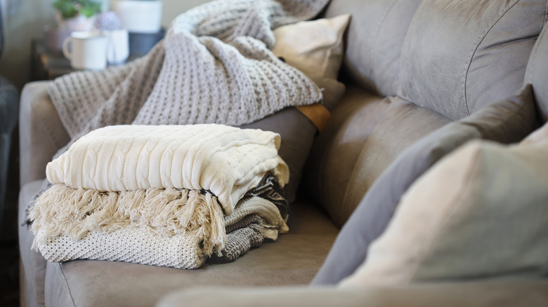 folded blankets on a couch