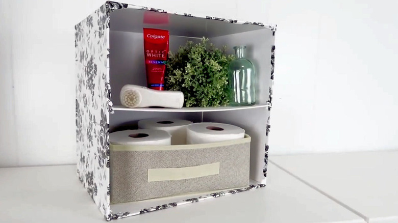 DIY storage cube with toilet paper and other bathroom essentials.