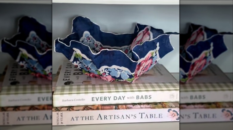 Blue floral handkerchief bowl sitting on stack of books
