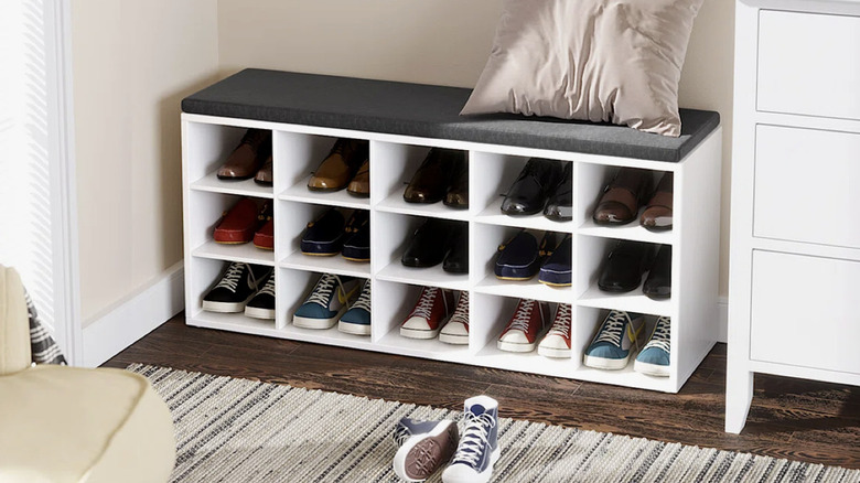 Shoe storage bench with cubbies and cushion on top