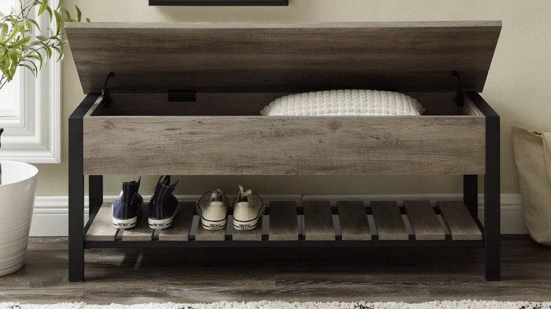 Red Barrel Studio Storage Bench in an entryway setting holding shoes and pillow inside