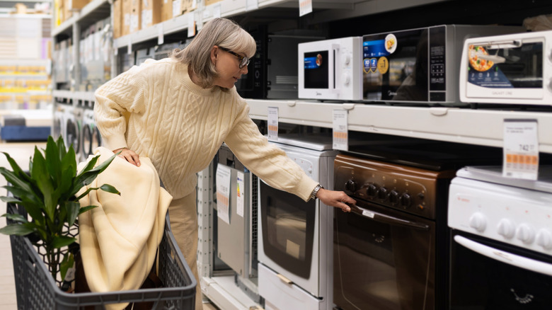A customer shopping for large appliances in a store