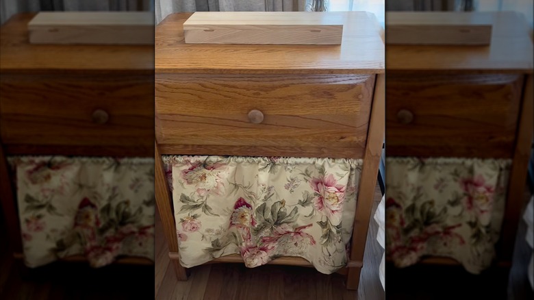 Screenshot for DIY of curtain hiding blankets in a bedside table