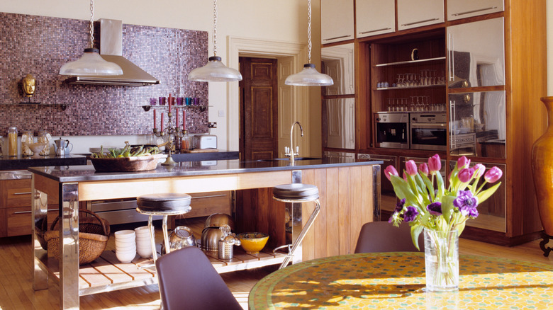 Vibrant, cozy kitchen with plum accents, including the backsplash and chairs.