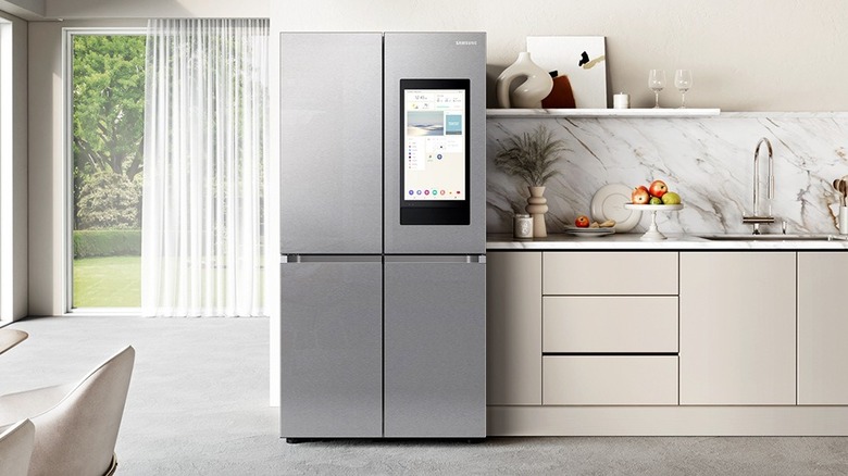 Neutral-colroed kitchen with a stainless steel Samsung refrigerator with a display screen