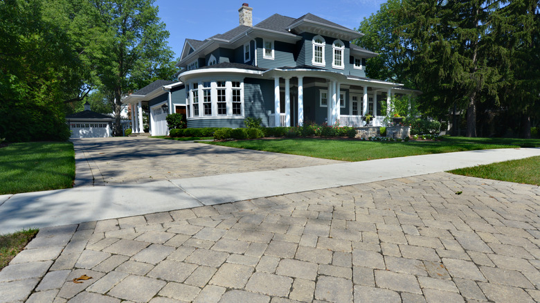 An attractive home with a paver driveway