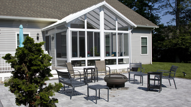 An outdoor patio seating area with chairs and a fire pit.