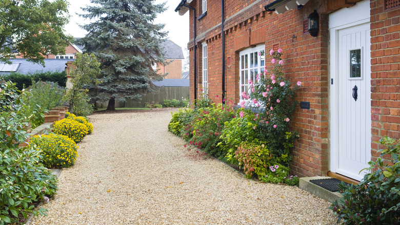 driveway with various flowers incorporated in landscaping