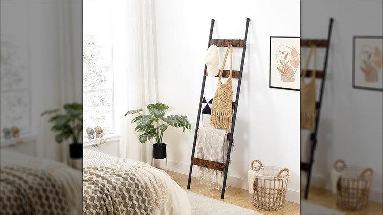 Blanket ladder with hooks holding hat, purse, and blankets