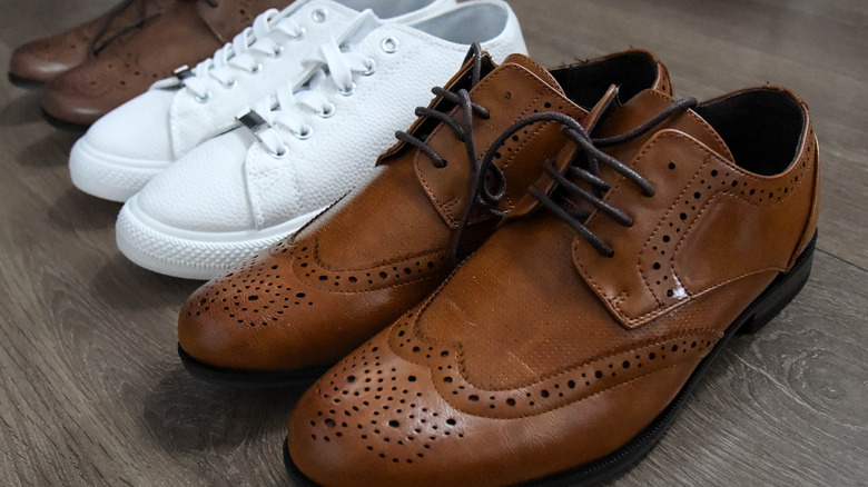 Multiple pairs of shoes lined up on the floor