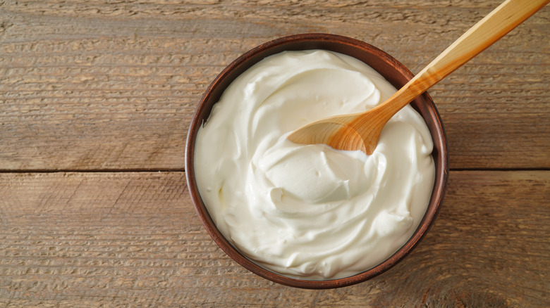 A cup of yogurt with a spoon in it