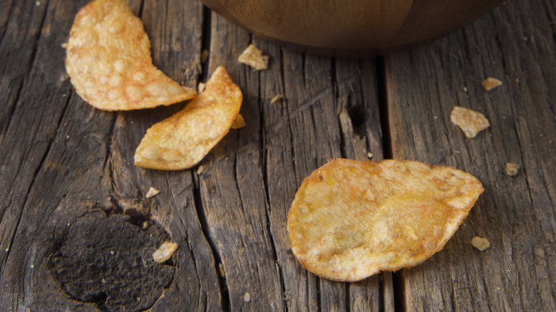 Chips and crumbs on a wooden table