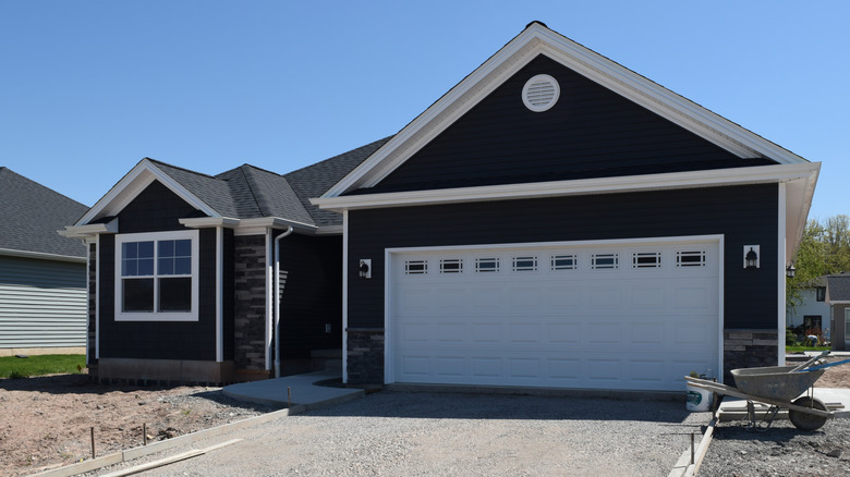 dark colored house with a concrete driveway