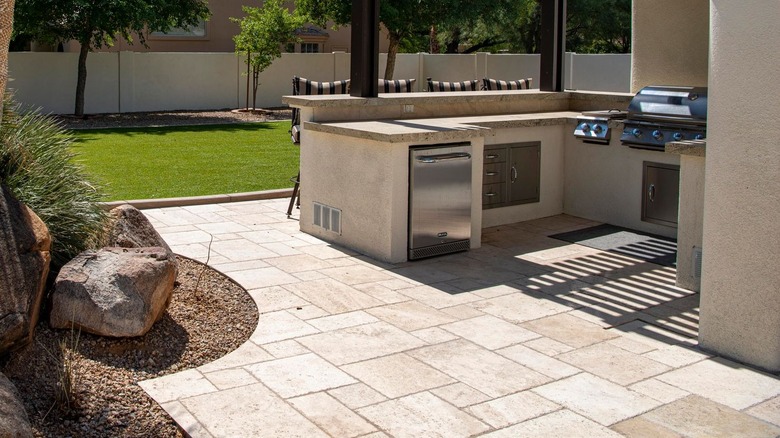 An outdoor dining area showing the natural tone and texture of limestone pavers