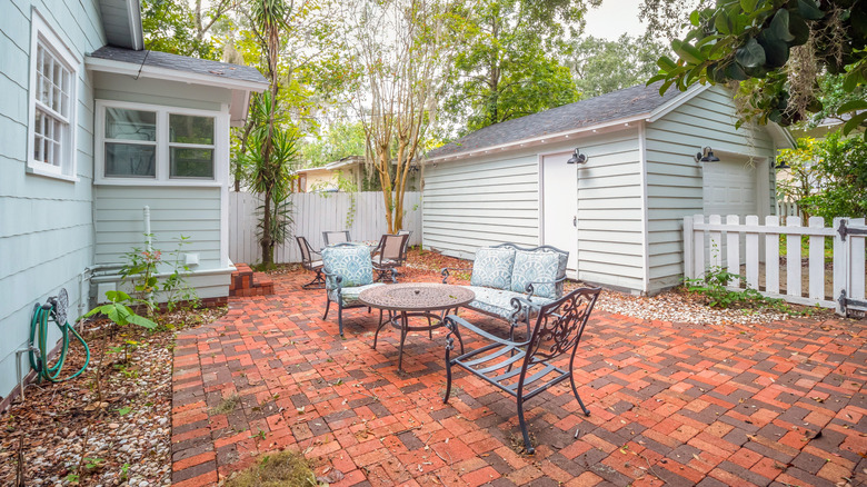 Backyard patio with a brick surface