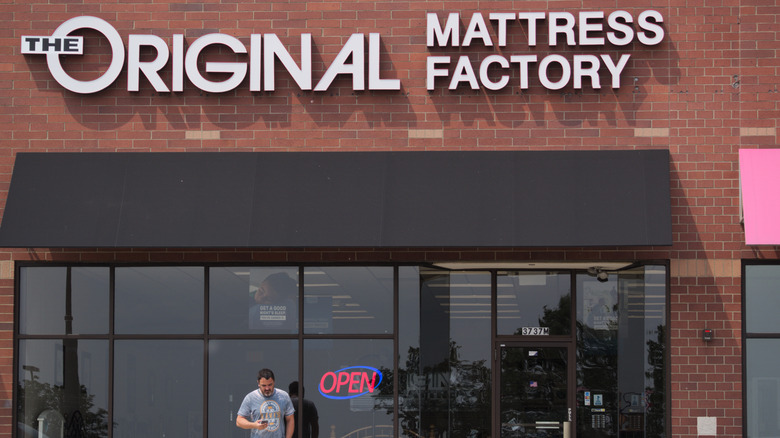 A person waiting outside The Original Mattress Factory