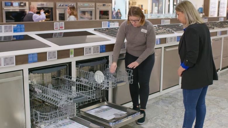 Salesperson helping a woman shop for dishwashers at Abt Electronics