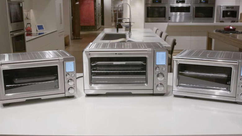 A trio of microwaves on a counter at Abt Electrical