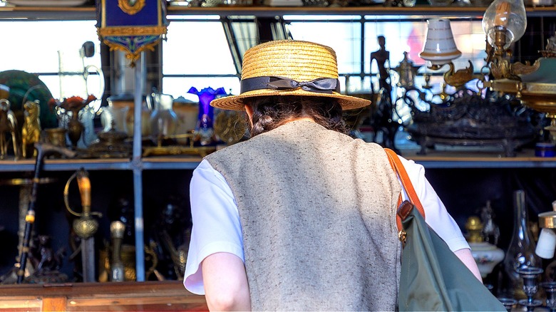 The back of someone as they search shelves filled with vintage items