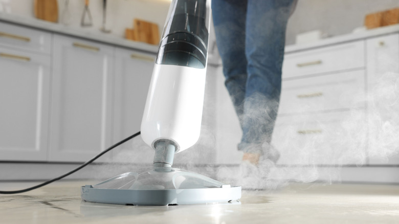 Person using steam mop on floor