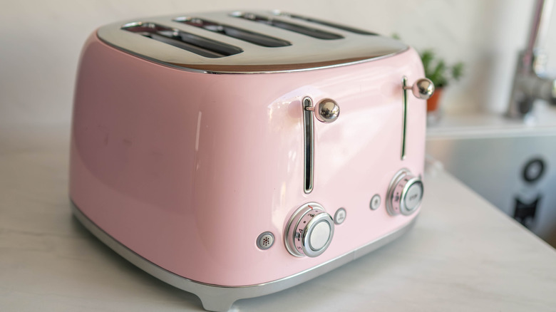 Closeup of a pink retro toaster