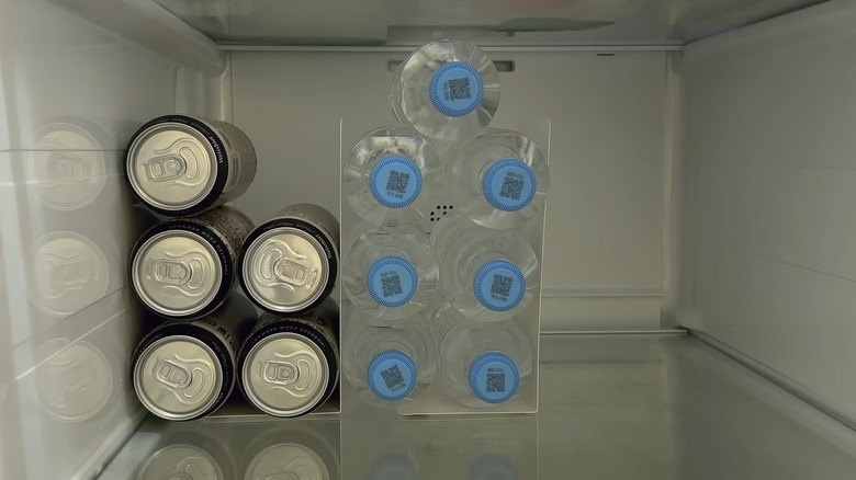 White bookends on fridge shelves holding drink bottles up