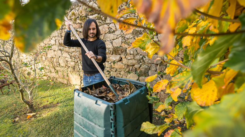 a man mixing his compost bin