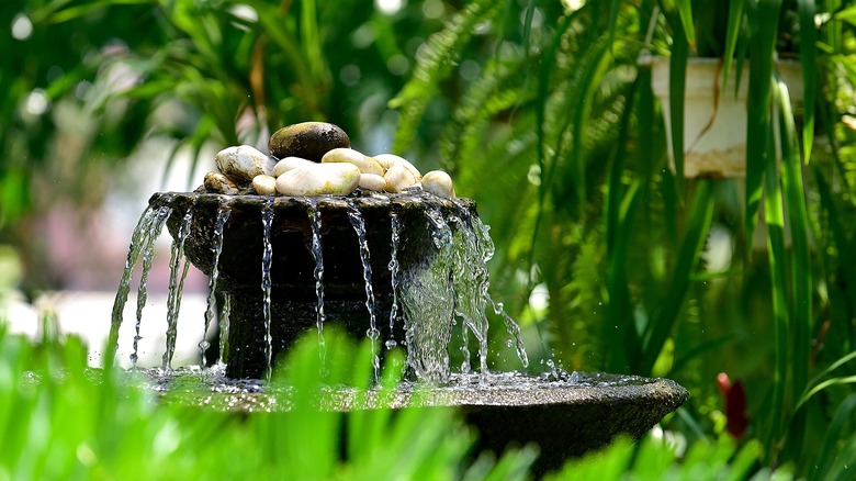 A two-tiered fountain inside a garden
